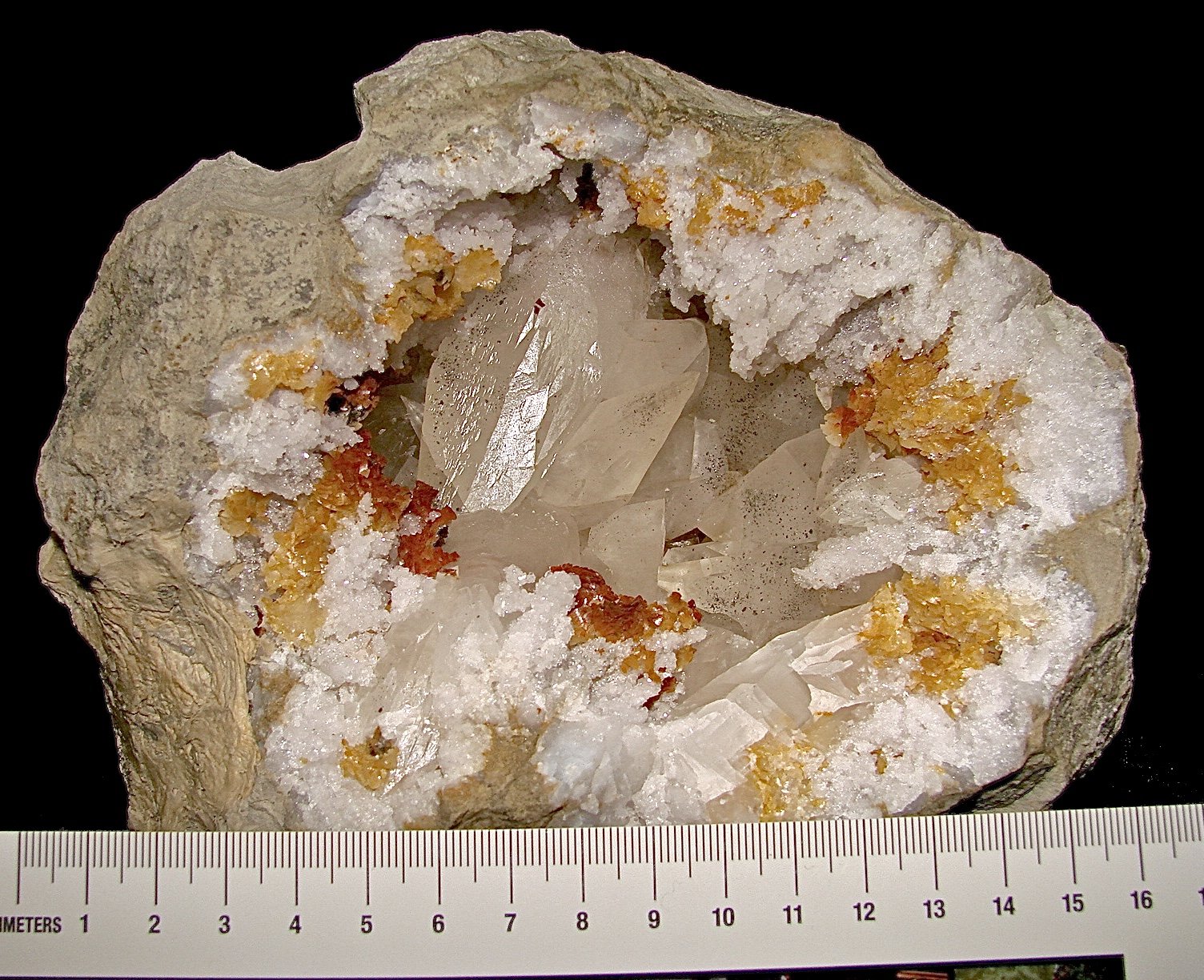 Calcite with Marcasite inclusions on Dolomite and Quartz
geode is about 14 cm,  cavity is about 10 cm, largest calcite is about 4.5 cm
(Autor: Bob Harman)