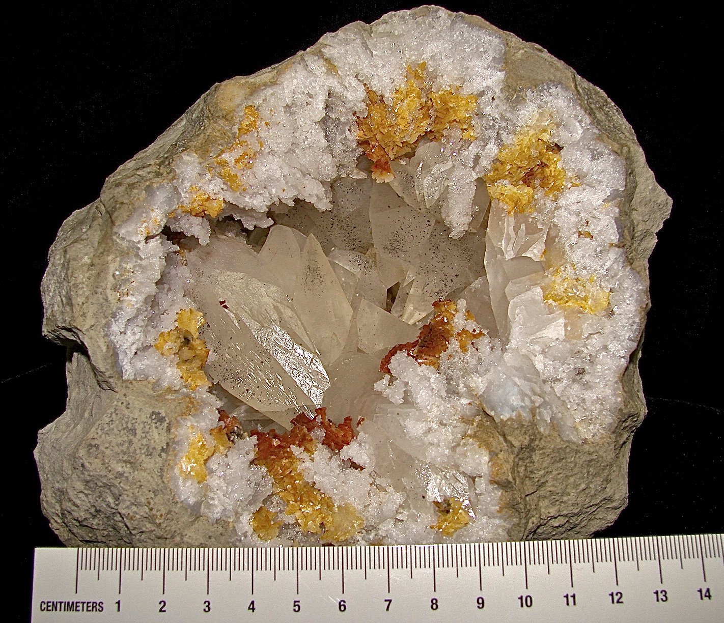 Calcite with Marcasite inclusions on Dolomite and Quartz
geode is about 14 cm,  cavity is about 10 cm, largest calcite is about 4.5 cm
(Autor: Bob Harman)