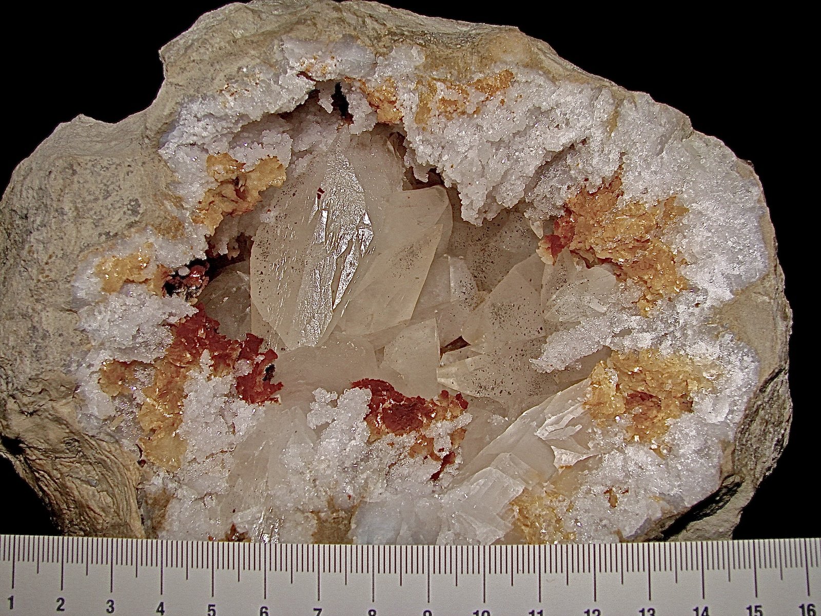 Calcite with Marcasite inclusions on Dolomite and Quartz
geode is about 14 cm,  cavity is about 10 cm, largest calcite is about 4.5 cm
(Autor: Bob Harman)