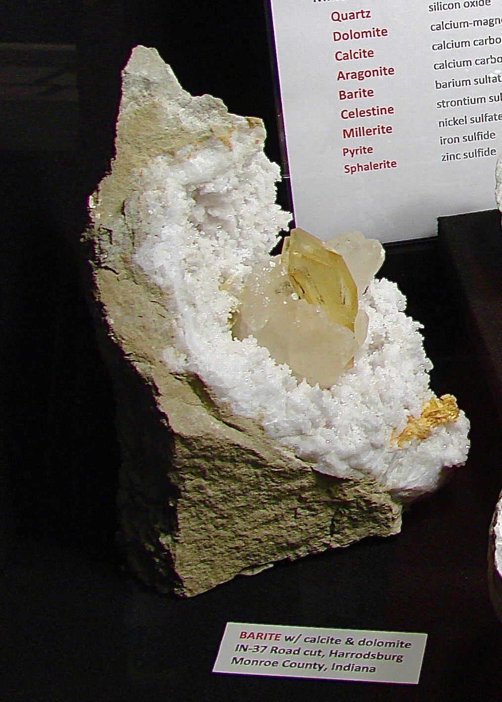 Baryte and Calcite and Dolomite on Quartz
Example is  22 cm.   The baryte is 3.8 cm.     The surrounding calcites are over  5 cm.
(Autor: Bob Harman)
