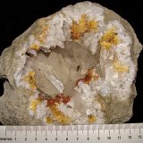 Calcite with Marcasite inclusions on Dolomite and Quartz
geode is about 14 cm,  cavity is about 10 cm, largest calcite is about 4.5 cm
(Autor: Bob Harman)
