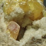 Azufre, calcita
0,7 x 0,4 cm (cristal anaranjado)
(Autor: Frederic Varela)
